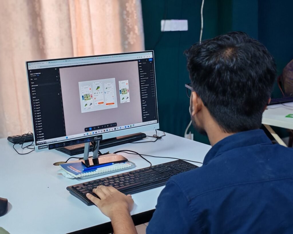 Young designer working on a user interface on a desktop computer