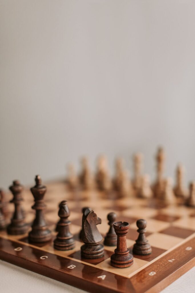 Close-up of chess pieces arranged on a board mid-game
