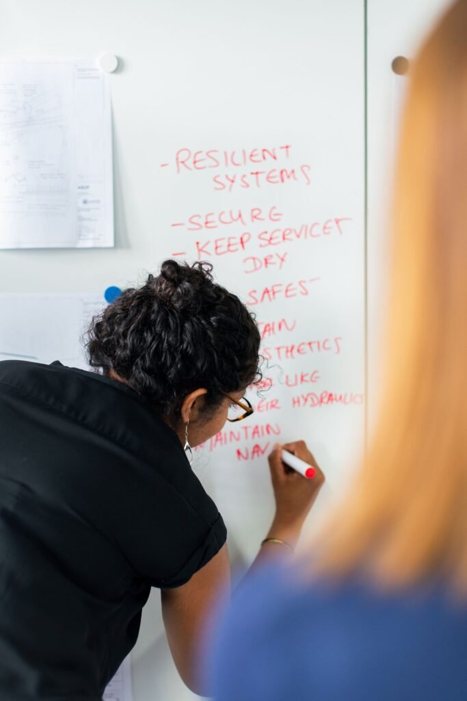 Engineer writing notes on a whiteboard