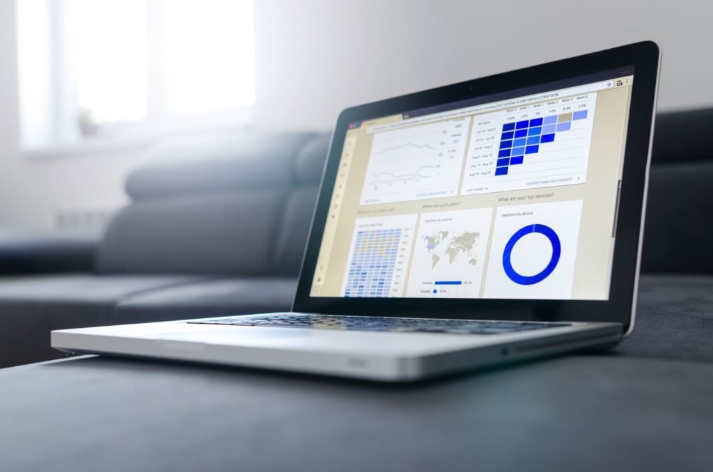 Laptop showing graphs and analytics in a bright room