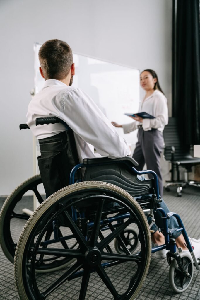 A man in a wheelchair taking part in a business meeting in an office