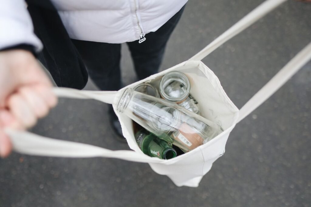 Empty glass bottles collected in a reusable bag