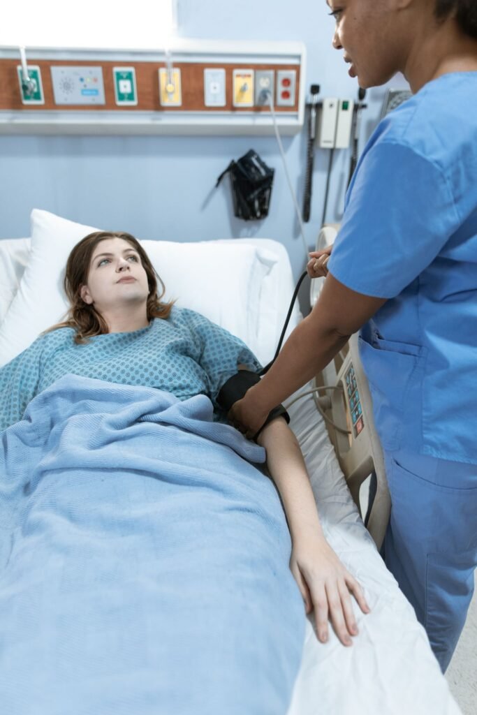 Nurse monitoring a patient's vital signs at a hospital bedside