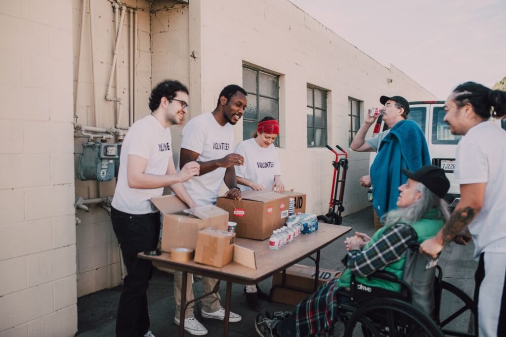 Volunteers handing out donated goods at an outdoor community event