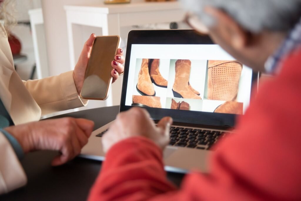 Two people looking at an online store on a laptop screen