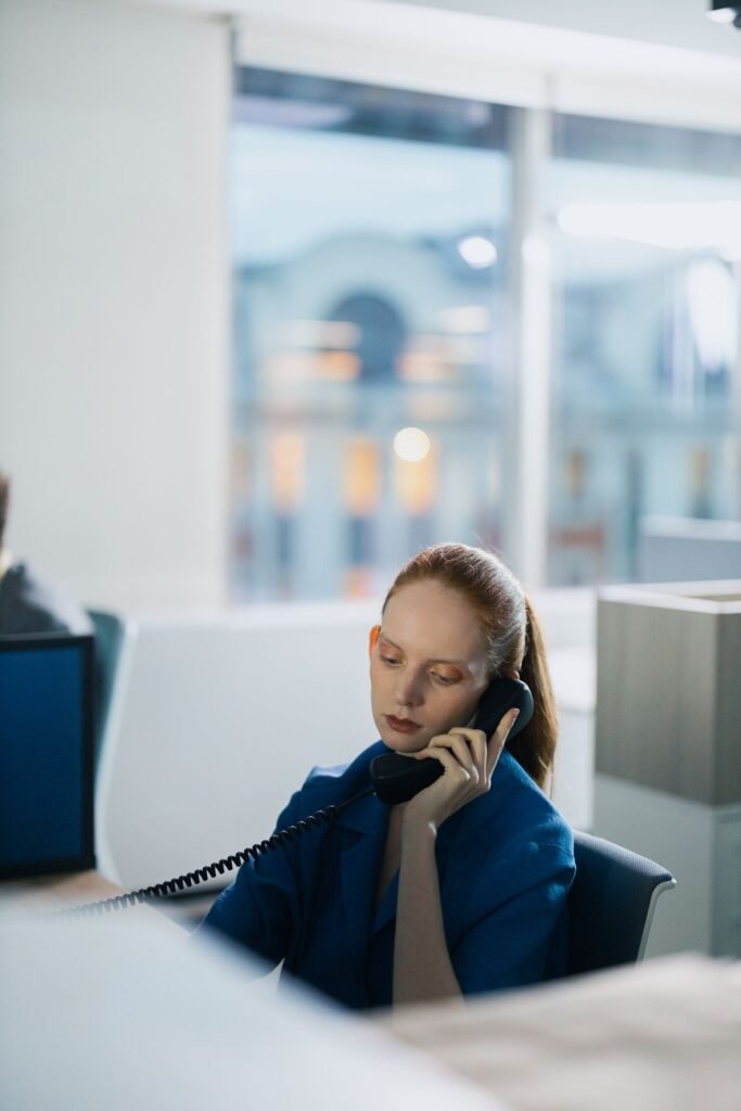 Businesswoman talking on the phone in an open plan office