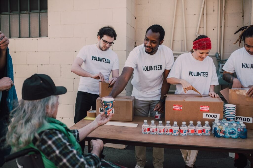 Volunteers handing out donations to people outdoors