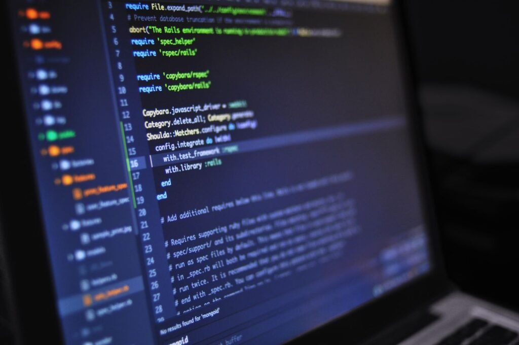 Close-up of programming code on a dark computer screen