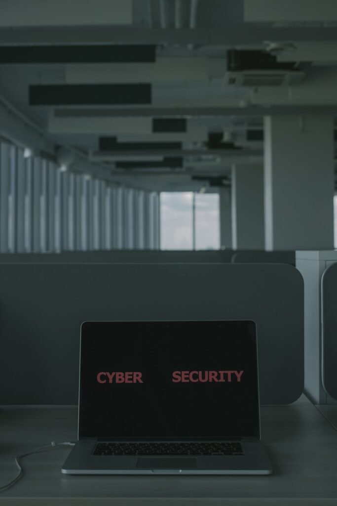 Laptop on a desk with the words cyber security on its screen